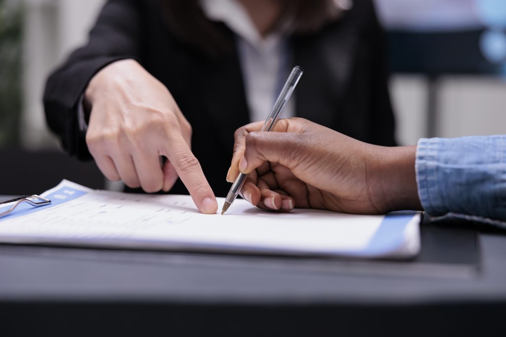 The current image has no alternative text. The file name is: Contract-Signing-scaled.jpg